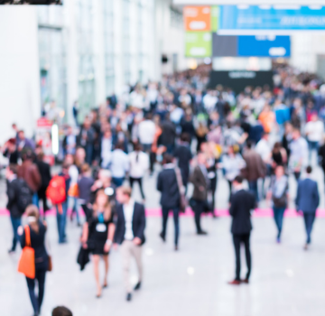 Blurred image of people walking at an event