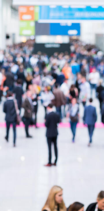 Blurred image of people walking at an event